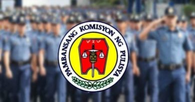 policemen behind the napolcom logo