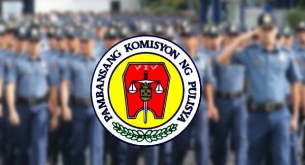 policemen behind the napolcom logo